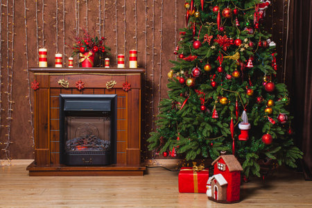 christmas tree at a wooden chimneyの写真素材