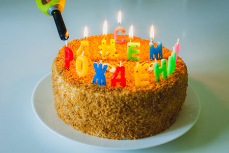 a birthday cake with letter shaped candles in russian