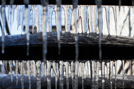 stairs cover with icicles during a thawの写真素材