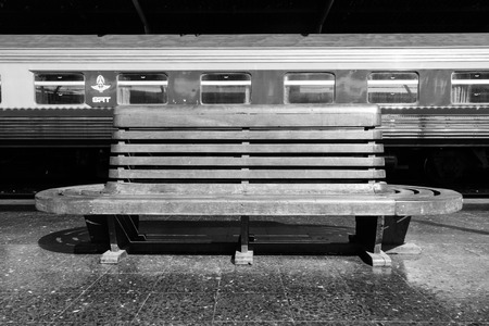 Old wooden bench at train platform.の写真素材