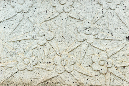 Vintage Thai Sculpture on wall on stone wall.の写真素材