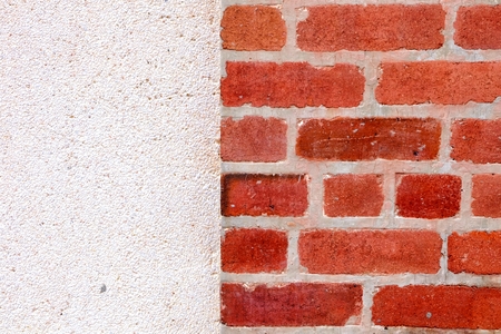 Haft Brick Wall with Concrete Wall Background.の写真素材