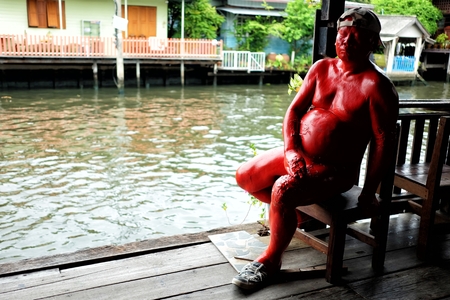 BANGKOK, THAILAND - JULY 26, 2017: Man statue in front of Bangkok Artist's House. Bangkok Artist's House is Thai Puppet Theatre that located on Bang Luang canal Bangkok Thailand.のeditorial素材