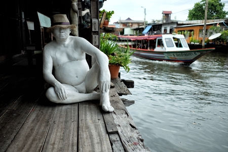 BANGKOK, THAILAND - JULY 26, 2017: Man statue in front of Bangkok Artist's House. Bangkok Artist's House is Thai Puppet Theatre that located on Bang Luang canal Bangkok Thailand.のeditorial素材