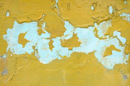 Yellow Peeling Paint on Concrete Wall Background.の写真素材