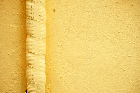 Air Duct on Yellow Paint Concrete Wall.の写真素材