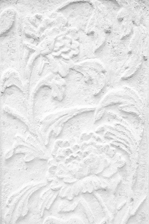 Vintage Thai Sculpture on Stone Wall.の写真素材