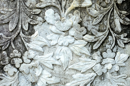 Vintage Thai Sculpture on Stone Wall.の写真素材