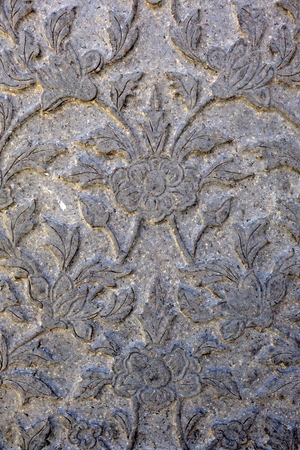 Vintage Thai Sculpture on Stone Wall.の写真素材