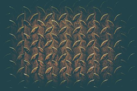 Old Rusty Diamond Plate in Dark Contrast with Vintage Background.の写真素材