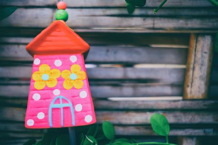 Ceramic House Hanging in The Park with Bamboo Fence Background.の写真素材
