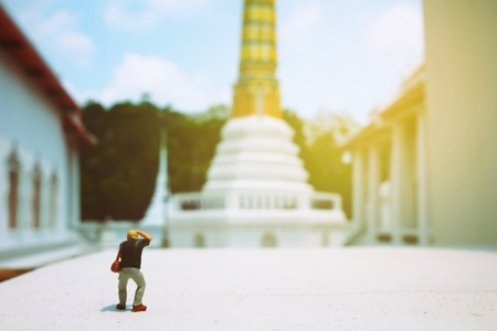 Miniature Figure Photographer Taking a Photo of  Ancient Pagoda in Thailand.の写真素材