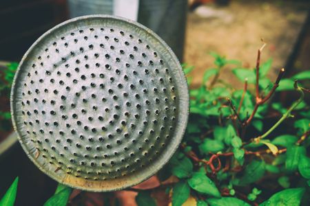 Closed-up Old Aluminum Watering Can in The Garden.の写真素材