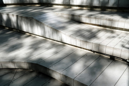 Wood Bench in the Park with Light and Shadow on Surface.の写真素材