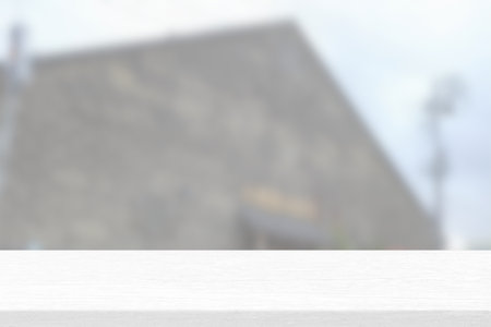 White Wood Table with Blurred Warehouse Background, Suitable for Product Presentation Backdrop, Display, and Mock up.の写真素材