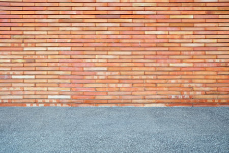 Red Brick Wall Background with Sand Pavement.の写真素材