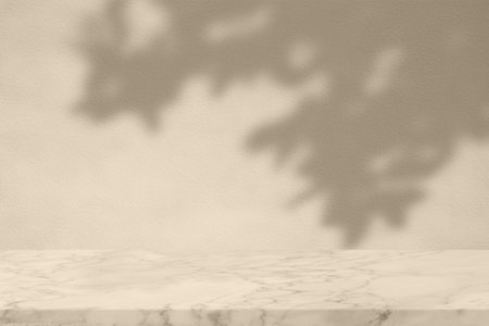 White Marble Table with Bokeh Light on Concrete Wall Texture Background in Set Sail Champagne Color Tone, Suitable for Product Presentation Backdrop, Display, and Mock up.の写真素材