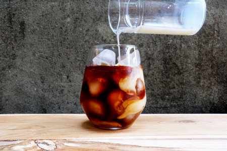 Cold Brew Black Coffee with Pouring Fresh Milk.の写真素材