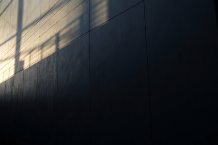Fence Shadow and Evening Light on Surface of Concrete Wall.の写真素材