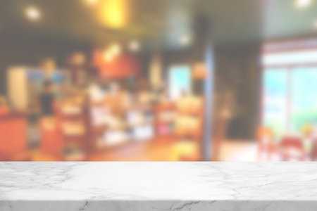 Marble Table with Blurred Cafe Interior Background, Suitable for Product Presentation Backdrop, Display, and Mock up.の写真素材