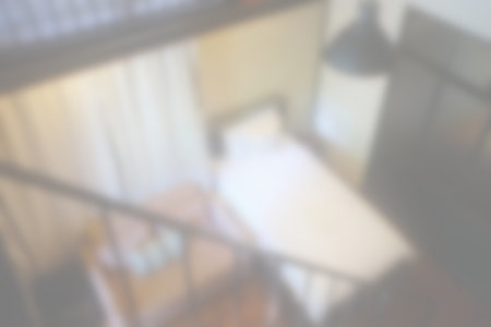 White Blurred Single Bed Room in Hotel Background.