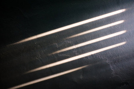 Sunlight Beam on the Dark Concrete Wall Background.の写真素材