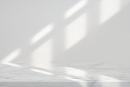 Marble Table with White Stucco Wall Texture Background with Light Beam and Shadow from the Window, Suitable for Product Presentation Backdrop, Display, and Mock up.の写真素材