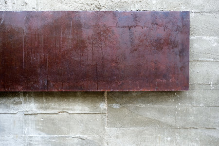Rusty Metal Plate on Raw Concrete Wall Texture Background.の写真素材