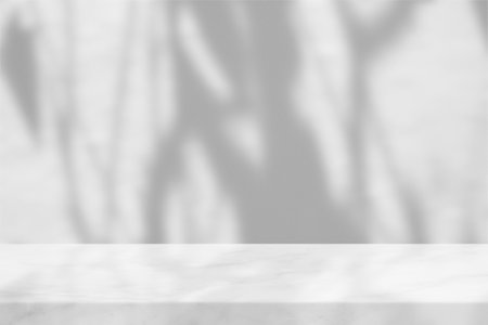 White Marble with Leaves Shadow on Concrete Wall Background.の写真素材