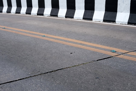 Concrete Road with Black and White Barrier.
