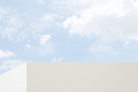 White Concrete Wall at the Corner with Minimal White Cloud and Blue Sky Background, Suitable for...