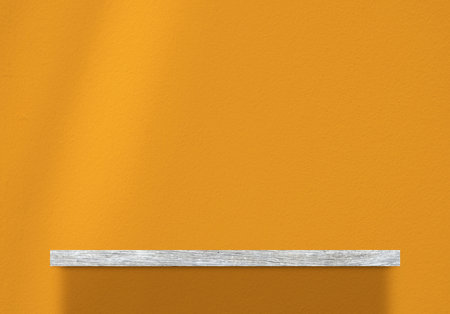 Wooden Bookshelf over Brave Ground Color Concrete Wall Background, Suitable for Product Presentation Backdrop, Display, and Mock up.の写真素材