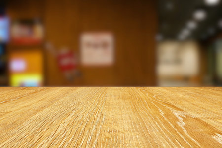 Wooden Table with Blurred Coffee Shop Background, Suitable for Product Presentation Backdrop, Display, and Mock up.の写真素材