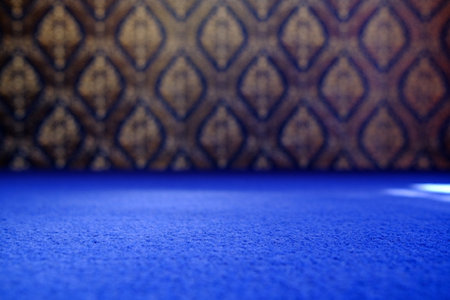 Blue Carpet Floor (Selective Focus) with Blurred Vintage Traditional Thai Mural Art Background, Suitable for Product Presentation Backdrop, Display, and Mock up.の写真素材