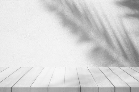 Wood Table with Coconut Leaves Shadow on Concrete Wall Texture Background, Suitable for Product Presentation Backdrop, Display, and Mock up.の写真素材