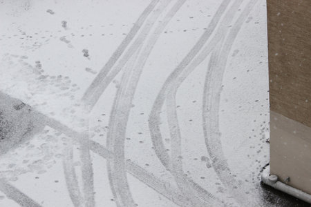 Car tire tracks in the snow, close-up. Winter backgroundの写真素材