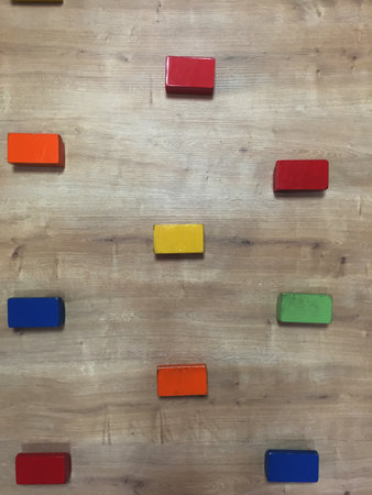 Wooden building blocks on a wooden background. Top view. Copy space.