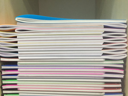 Stack of colorful magazines on shelf in the library, close-up