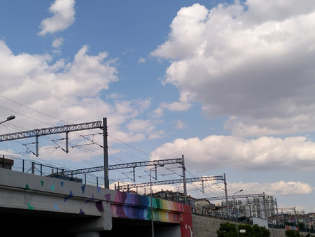 High-voltage power lines in the city against the blue sky