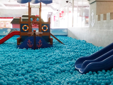 Children's playground with blue plastic balls in the shape of a shipの写真素材