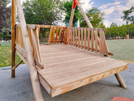 Wooden swing on a playground in a park. Horizontal.の写真素材