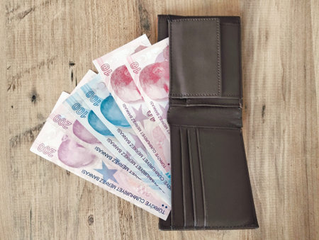 Polish zloty banknotes in leather wallet on wooden background