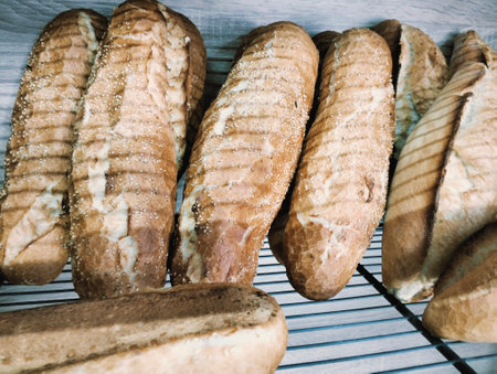 Freshly baked baguettes on a wooden background. Toned.