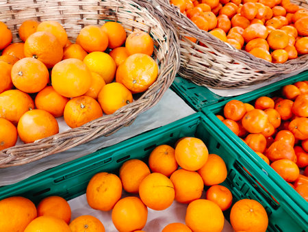 Ripe tangerines in baskets on the counter of the storeの写真素材