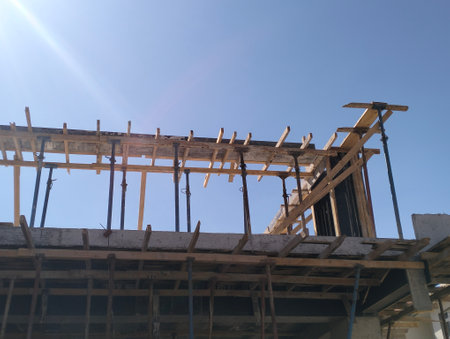 Construction of a new house with blue sky in the background. House under construction.