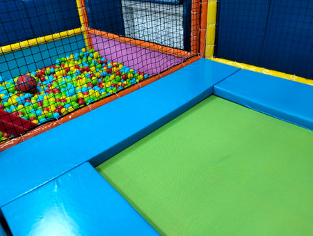 Trampoline in a children's entertainment center with colorful balls.