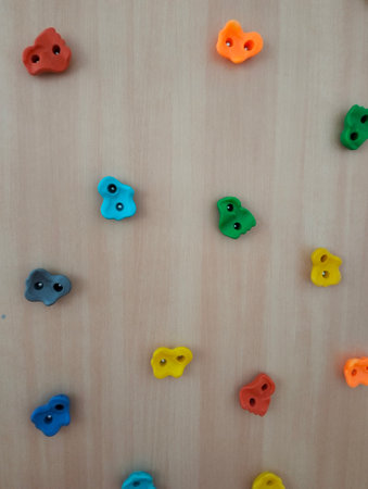 Colorful plastic buttons on a wooden background. Selective focus.