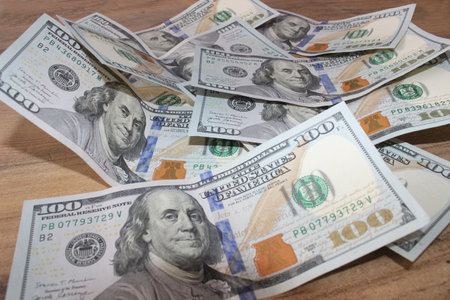 Dollars on a wooden table. Money background. Business background.の写真素材