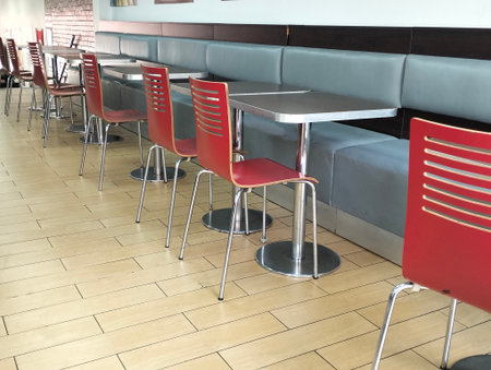 Interior of a cafe with red chairs and tables, stock photo