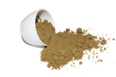 Brown powder in a cup isolated on a white background.